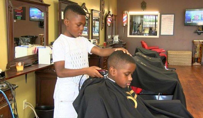 Two kids inside a barber shop.