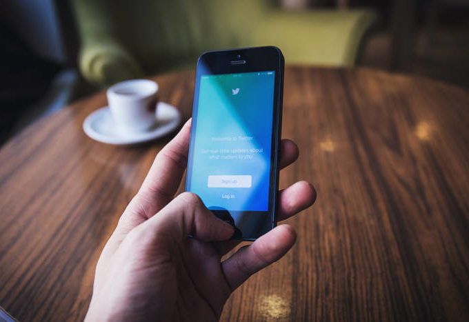 Hand holding an iPhone.
